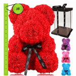 Red rose teddy bear with a black ribbon beside a gift box