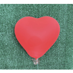 Red heart-shaped balloon on a green textured background