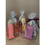 Three wrapped cleaning gift sets with soap bottles and scrub brushes