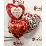Three heart-shaped Valentine's Day balloons in red, white, and pink.