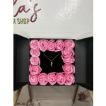 Pink rose-shaped flowers arranged in a square gift box with a necklace in the center.