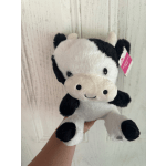 Black-and-white plush cow toy with a hanging tag