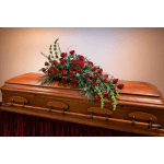 Red rose casket spray on a wooden coffin