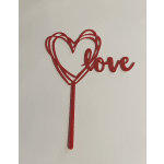 Red heart-shaped "love" cake topper on a stick