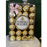 Box of Ferrero Rocher chocolates with a pink ribbon