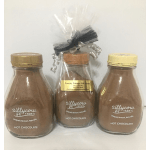 Three jars of hot chocolate mix, one wrapped with a ribbon.