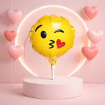 Yellow emoji balloon with pink heart balloons on a pastel pedestal