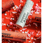 Lip balm tubes scattered with pink and white candy sprinkles