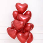 Cluster of red heart-shaped balloons against a white background