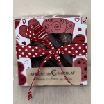A boxed chocolate gift tied with a red polka-dot ribbon