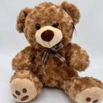Brown teddy bear with a plaid ribbon bow