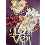 Assorted Valentine’s Day wooden cake toppers with hearts and love messages