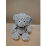 White plush teddy bear with a plaid ribbon and hanging tag