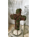 Moss-covered wire cross on a metal stem in a glass jar