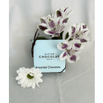 Assorted chocolates in a light blue box with white and purple flowers