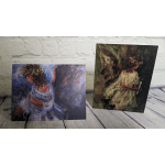 Two art prints of girls in flowing dresses against a brick wall