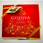 Red Godiva chocolate box tied with a gold ribbon