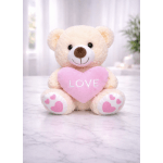 Plush teddy bear holding a pink heart with the word LOVE