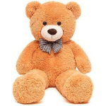 Large tan teddy bear with a checkered bow tie