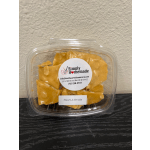 Plastic container of peanut brittle candy with a label