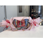 Candy bouquet wrapped in pink paper with ribbon bows