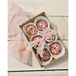 Box of pink decorated chocolates tied with a sheer pink ribbon