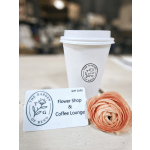 White coffee cup with a gift card and a peach ranunculus bloom