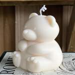 White bear-shaped candle with a wick on top
