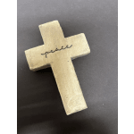 Beige cross-shaped ornament with the word peace written across it