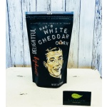 Black pouch of Dad's White Cheddar Corn on a white surface