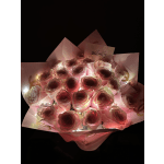 Bouquet of pink roses wrapped in pink paper with lights