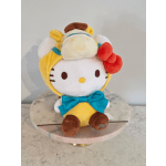 Plush Hello Kitty character with a blue bow sitting on a round stand