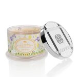 Decorative scented candle in a glass jar with a metal lid