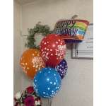 Birthday balloons with a small flower arrangement below