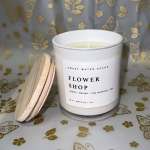 White scented candle in a glass jar with a wooden lid