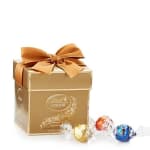 Gold gift box with a ribbon bow and assorted Lindt chocolates