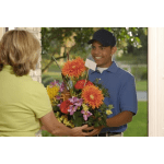 Mixed bouquet with orange daisies and purple flowers in a container