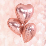 Three rose gold heart-shaped balloons against a pale pink background