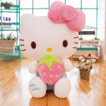Large Hello Kitty plush holding a pink strawberry