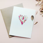 Greeting card with a colorful geometric heart on the front