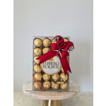 Box of Ferrero Rocher chocolates with a red ribbon bow