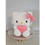 Hello Kitty plush holding a pink heart