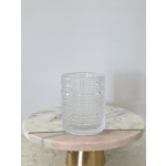 Clear textured glass votive holder on a round marble stand