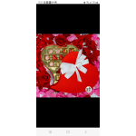 Heart-shaped gift box of chocolates on a bed of rose petals