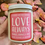 Jar candle labeled "Love Always" surrounded by pink rose petals