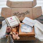 Gift box with soap bars, a candle, and dried flowers