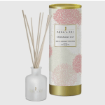 Reed diffuser in a frosted bottle beside its floral-patterned box