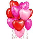 Cluster of heart-shaped balloons in red, pink, and magenta