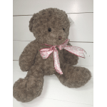 Brown plush teddy bear with a pink heart-pattern ribbon
