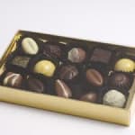 Box of assorted chocolates in a gold tray